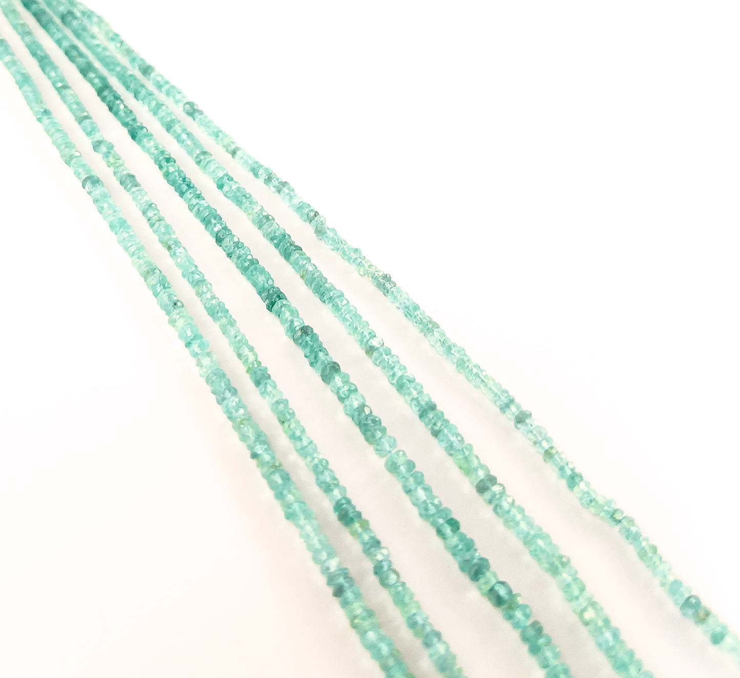 Apatite gemstones in faceted rondelle form, offering polished cuts, saturated blue‑green colour, and lively brilliance.