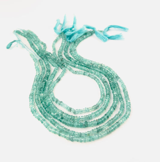 Apatite faceted rondelle beads sized 3.5–3.9mm and 4–4.5mm arranged in a 33cm strand, showing vivid aqua‑blue colour and bright sparkle.