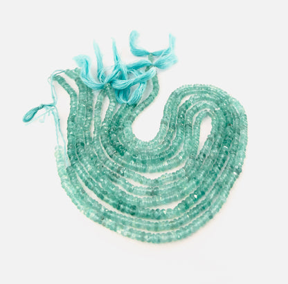 Apatite faceted rondelle gemstones with crisp faceting and strong neon‑blue tones across a 33cm strand in two size ranges.