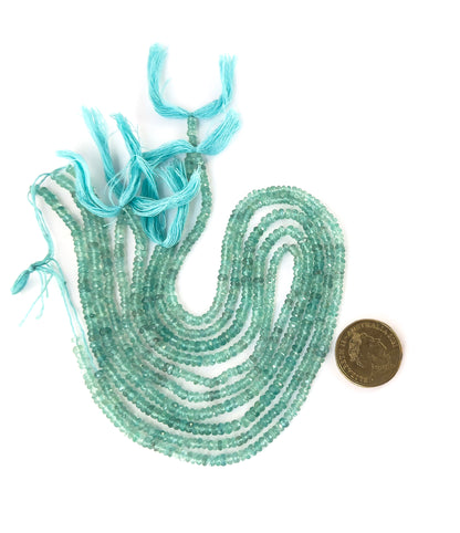A coin is placed near Apatite faceted rondelle beads to show the 3.5–4.5mm size range.