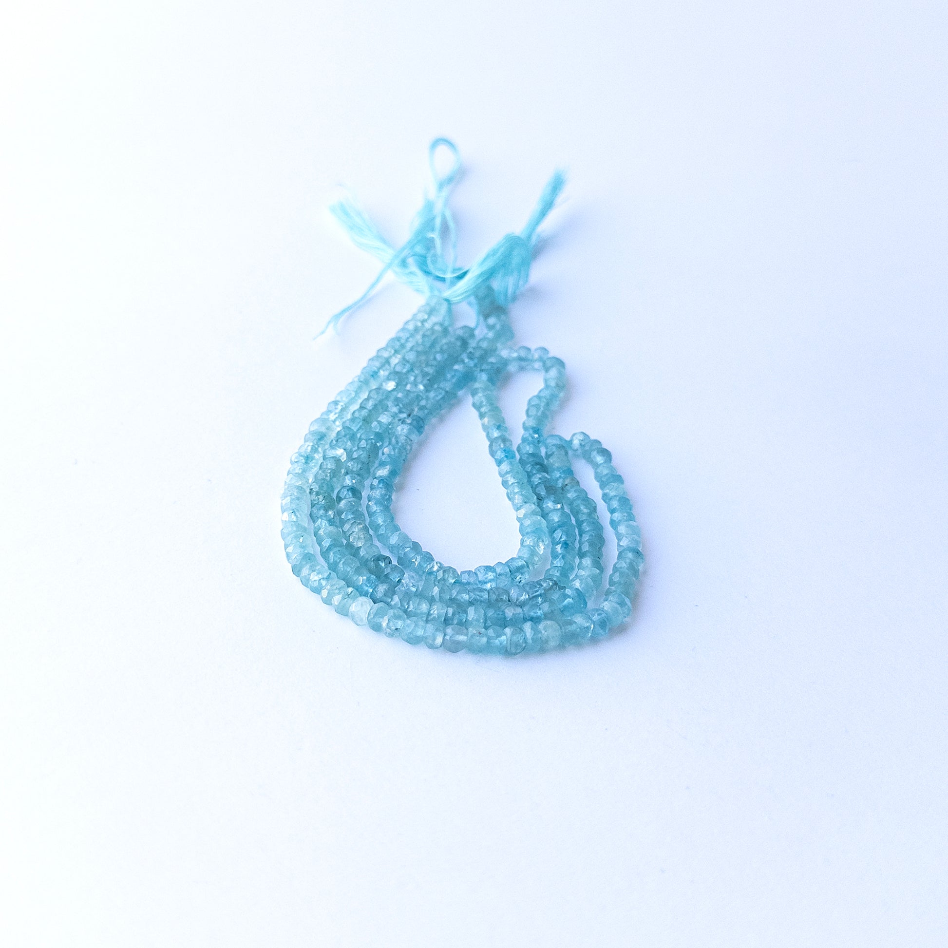 Handmade jewellery components featuring natural Apatite faceted rondelles, highlighting their colour, clarity, and shimmering finish.
