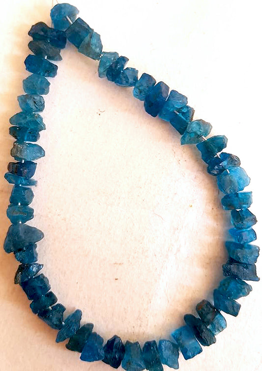 Rough Apatite beads with raw texture and vibrant blue-green hues in a 49-piece strand.