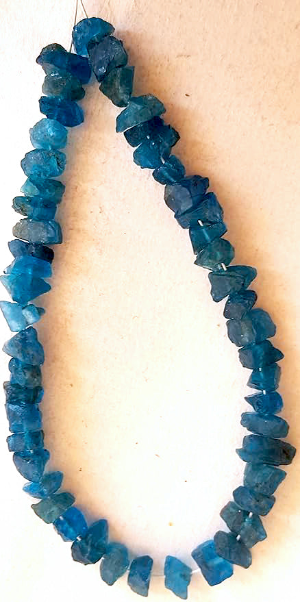 Strand of Apatite beads with uncut finish and rich colour saturation across 82 carats.