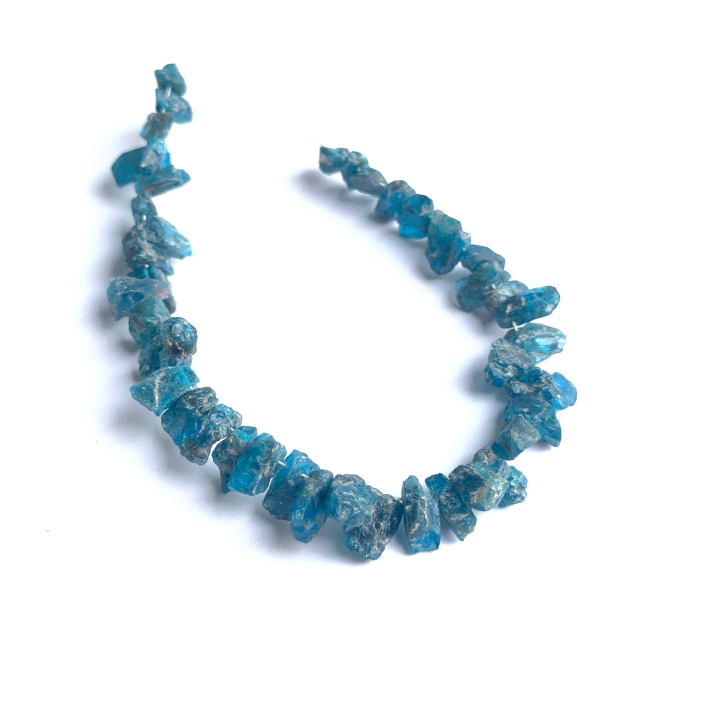 Close‑up of apatite rough beads highlighting their organic shape and vibrant colour for DIY jewellery.
