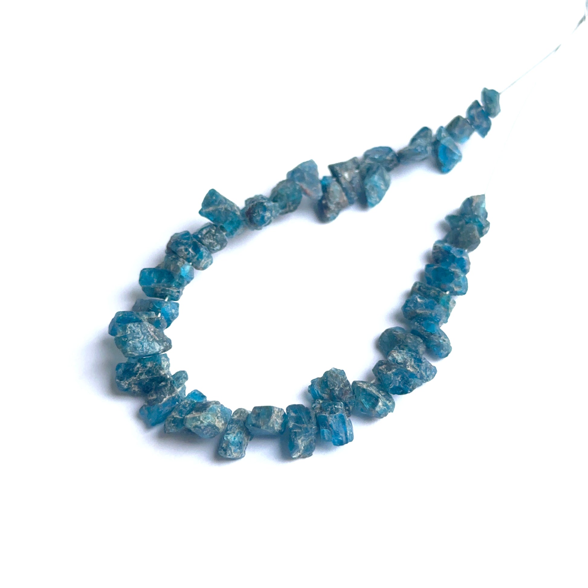 Apatite rough natural gemstone beads showing bright blue tones and raw texture for handmade jewellery.