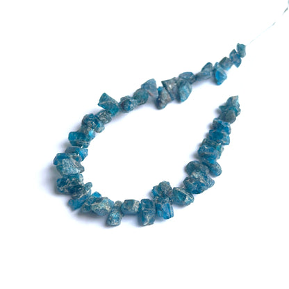 Apatite rough natural gemstone beads showing bright blue tones and raw texture for handmade jewellery.