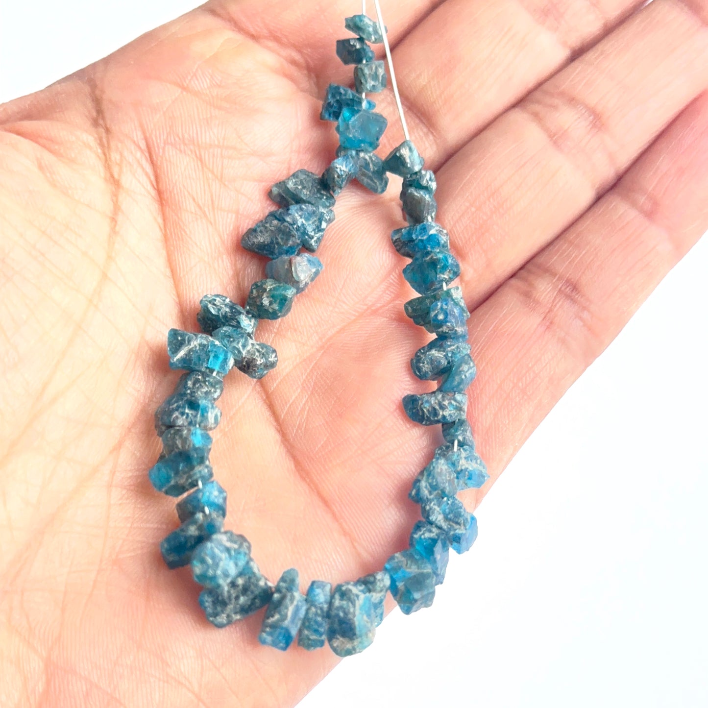 Raw apatite beads displayed with visible texture ideal for natural gemstone beads in jewellery making.