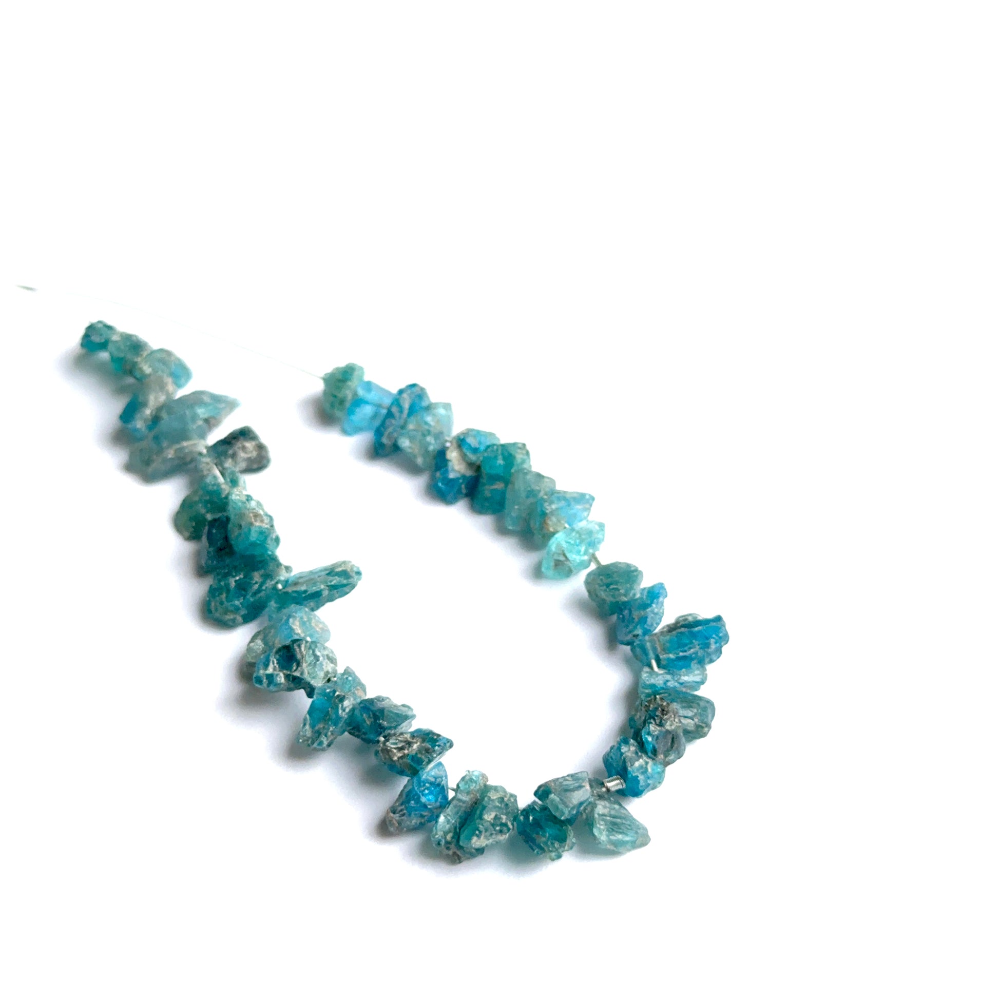 Apatite rough natural gemstone beads showing bright blue tones and raw texture for handmade jewellery.
