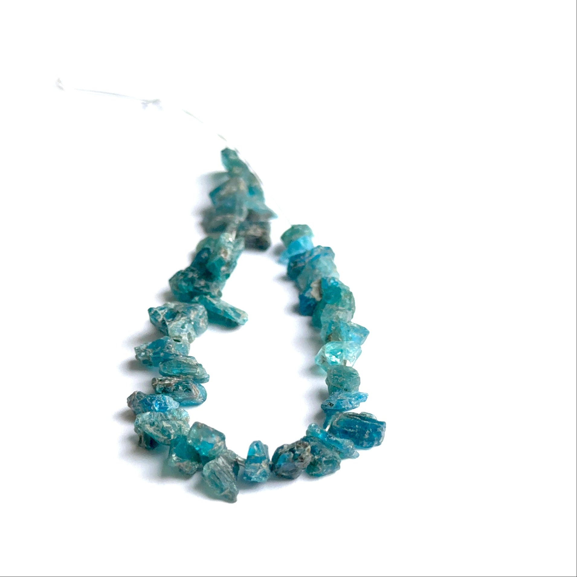 Raw apatite stones displayed with visible texture ideal for natural gemstone beads in jewellery making.
