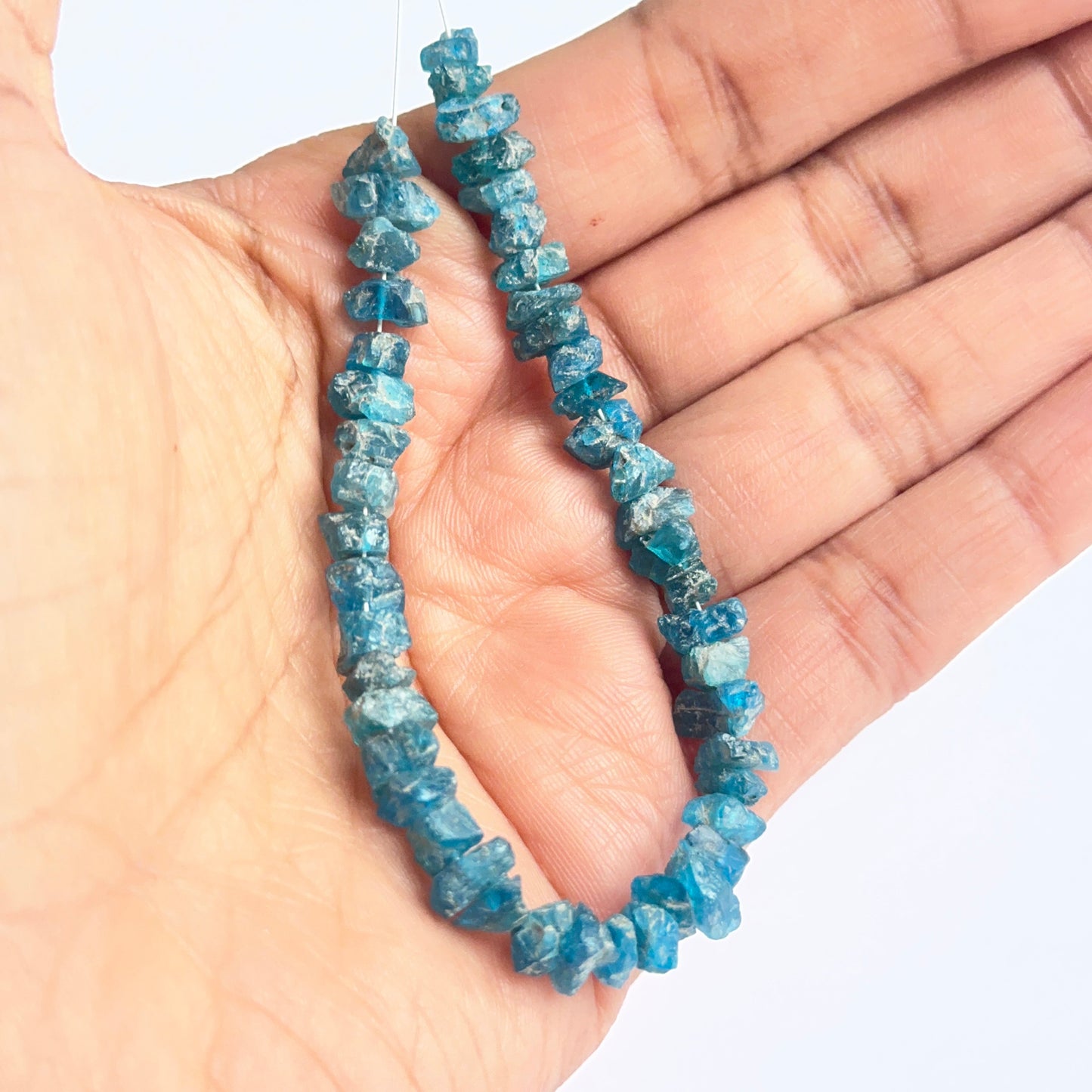 Raw apatite beads displayed with visible texture ideal for natural gemstone beads in jewellery making.