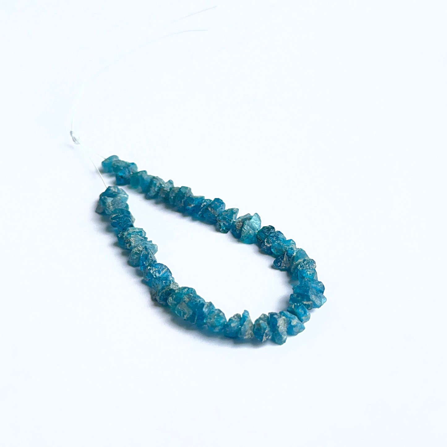 Apatite rough natural gemstone beads showing bright blue tones and raw texture for handmade jewellery.