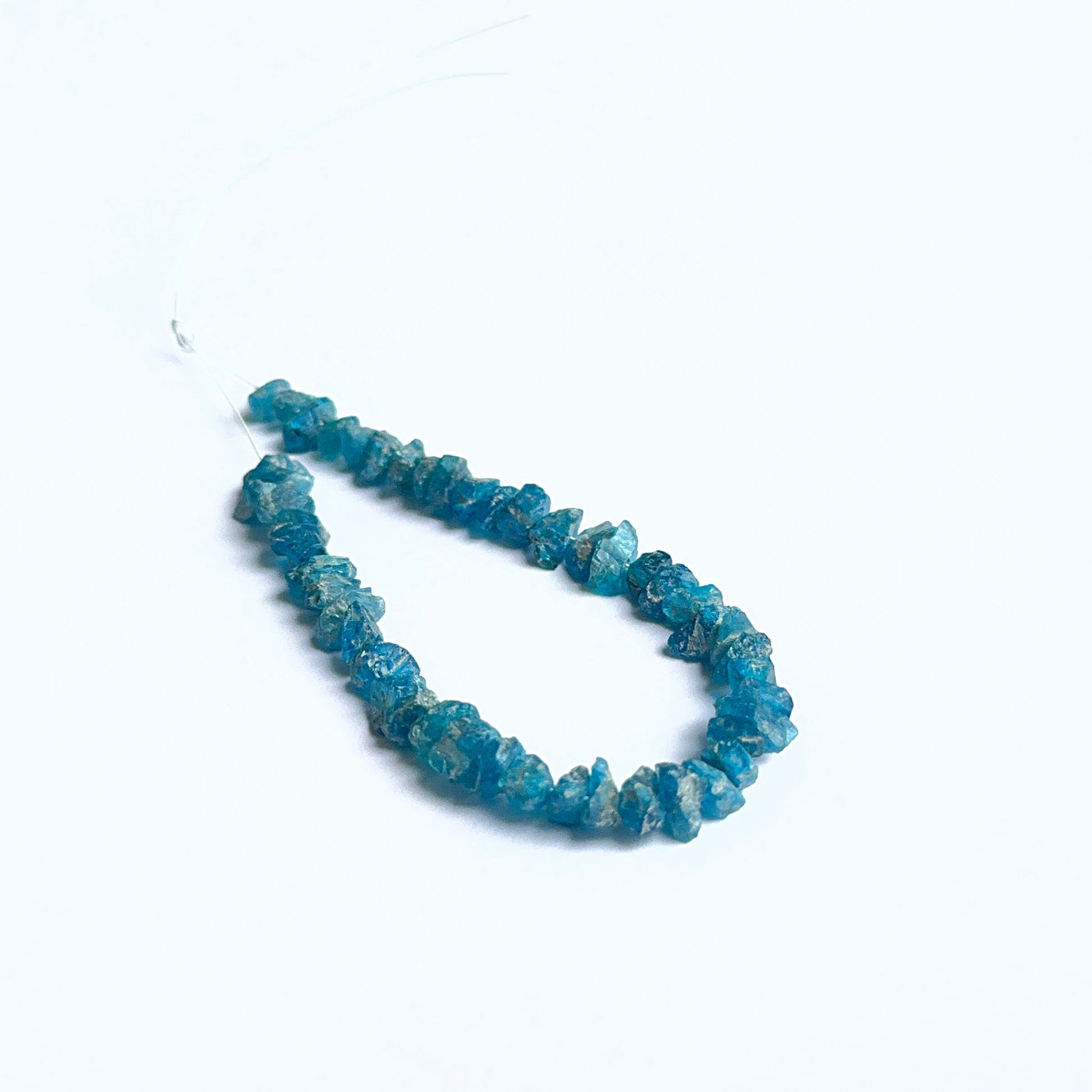 Apatite rough natural gemstone beads showing bright blue tones and raw texture for handmade jewellery.