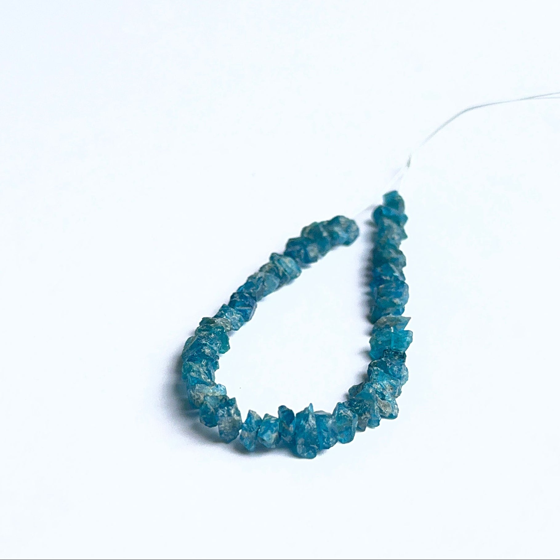 Close‑up of apatite rough beads highlighting their organic shape and vibrant colour for DIY jewellery.