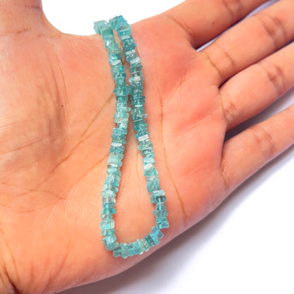 A dial gauge measures the Apatite smooth heishi 4.1–4.3mm gemstone.