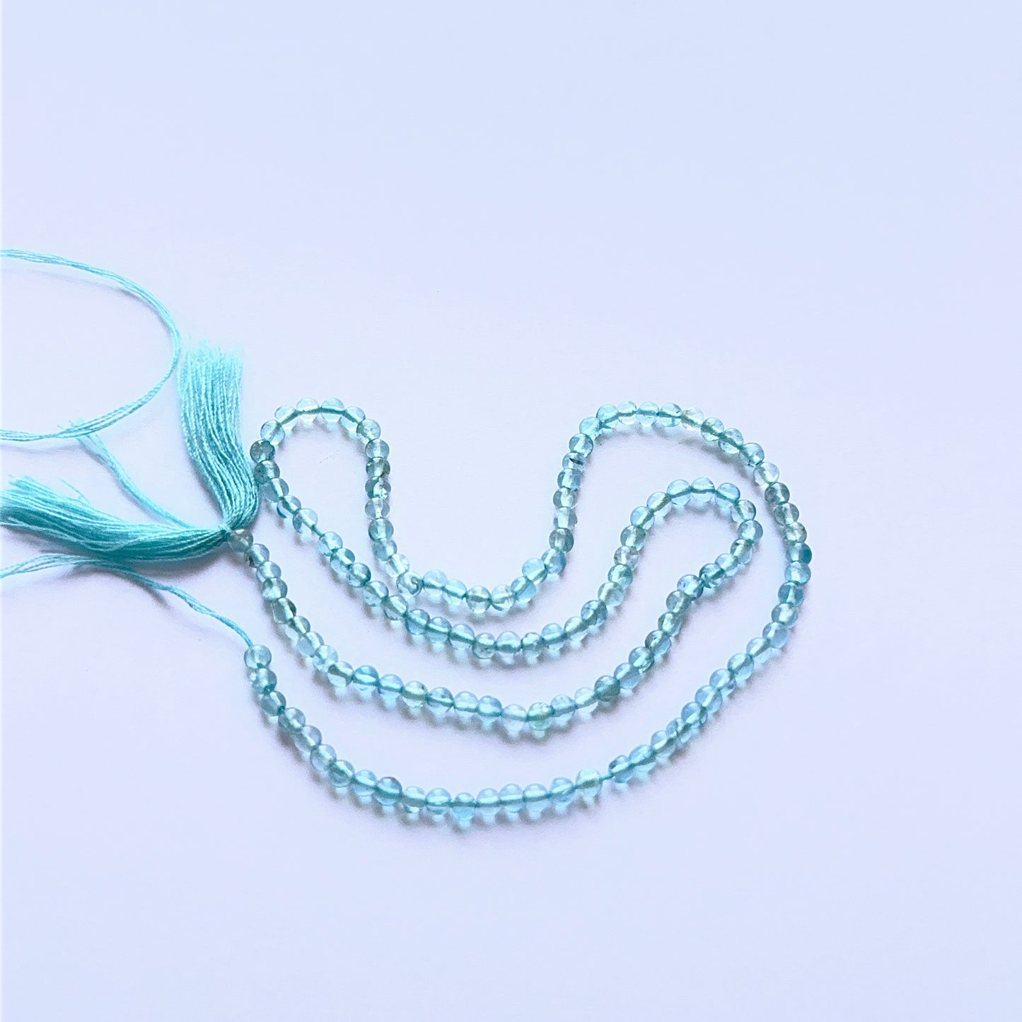 Close‑up of 2.9mm Apatite stone beads showing polished round surfaces ideal for natural gemstone beads for DIY jewellery.