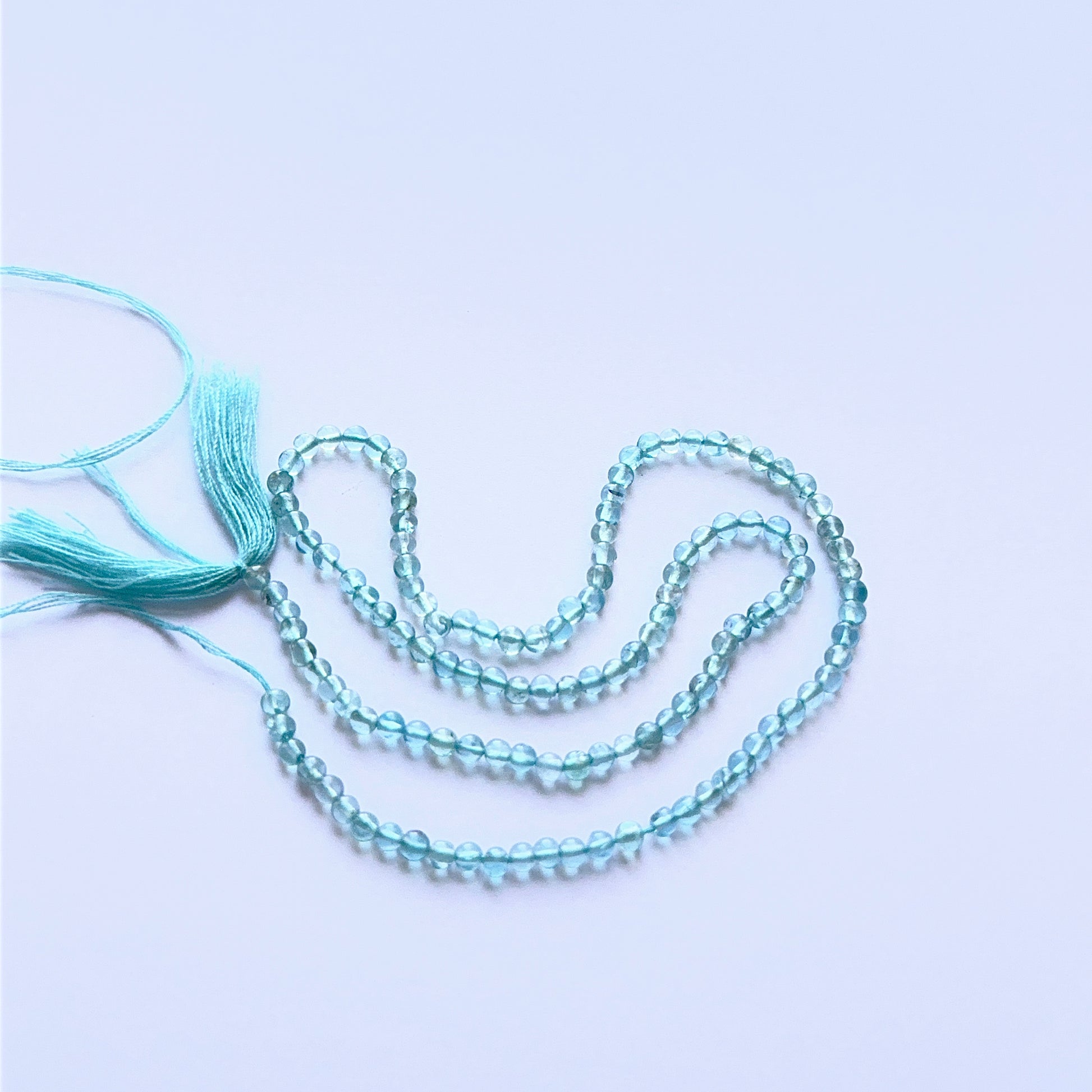 Close‑up of 2.9mm Apatite stone beads showing polished round surfaces ideal for natural gemstone beads for DIY jewellery.