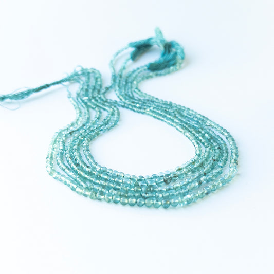 Close‑up of genuine apatite smooth round gemstone beads with natural shine for DIY jewellery making.
