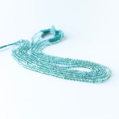 Authentic apatite stone beads in polished smooth round cuts showing vivid blue colour for jewellery design work.