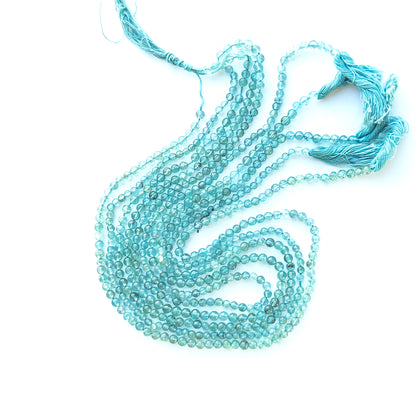Strand of apatite smooth rounds displaying ocean‑blue hues and glossy finish for gemstone beads for DIY jewellery.