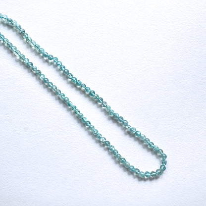 A dial gauge measures the Apatite smooth round 4.2mm gemstone.
