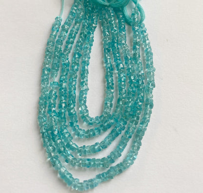 Exquisite Apatite smooth wheel beads 3.5mm arranged in a 16cm strand highlighting their bright blue hues and organic gemstone beauty.