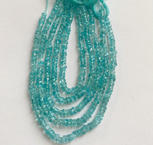 Exquisite Apatite smooth wheel beads 3.5mm arranged in a 16cm strand highlighting their bright blue hues and organic gemstone beauty.