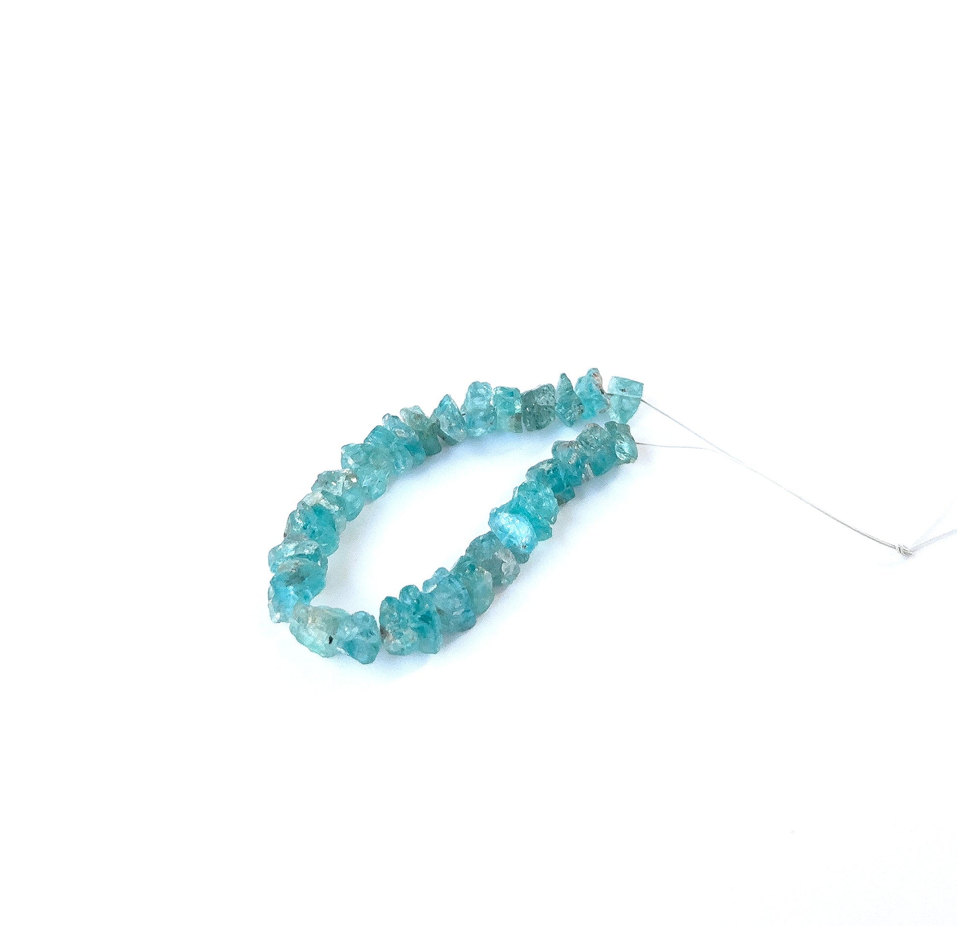 Close‑up of raw Apatite gemstone pieces with organic shapes, perfect for authentic gemstone bead jewellery.