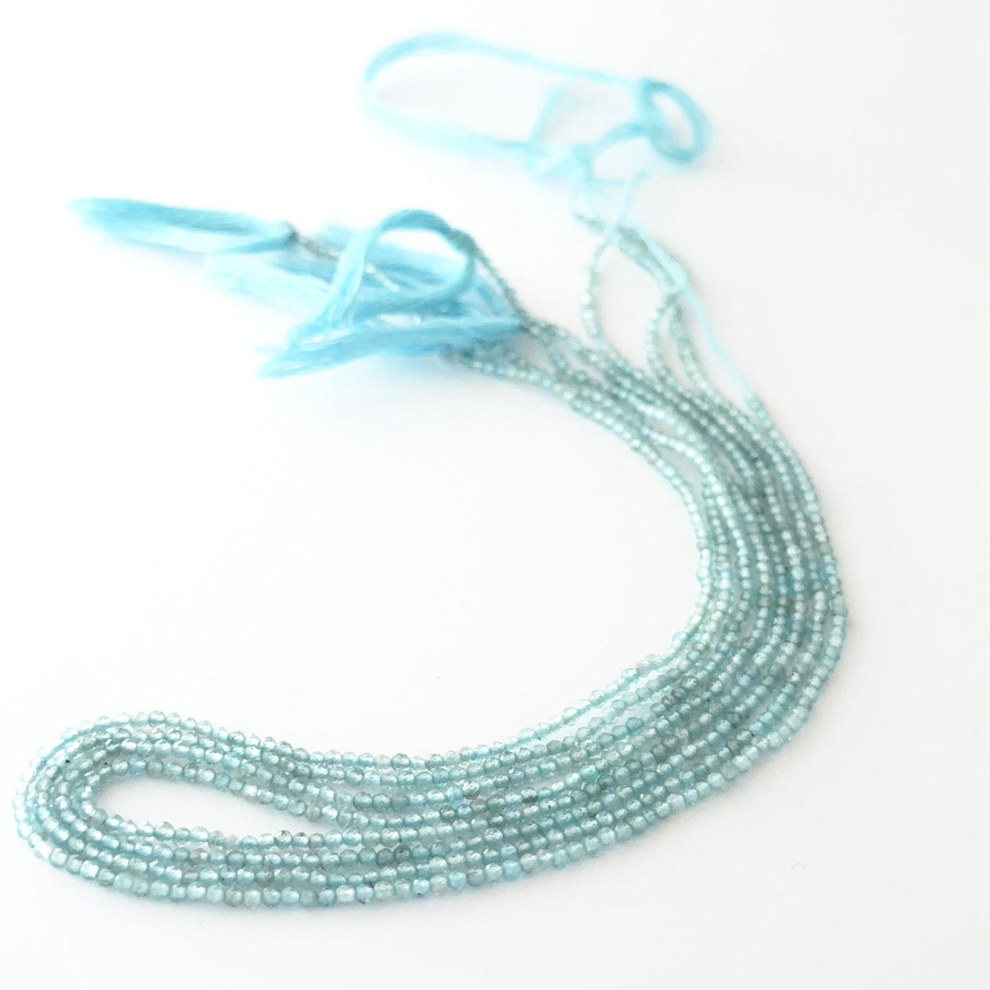 Close view of Aquamarine faceted rondelle beads showing cut, clarity and premium gemstone quality