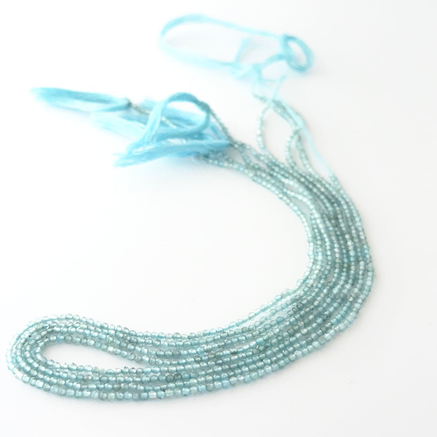 Close view of Aquamarine faceted rondelle beads showing cut, clarity and premium gemstone quality