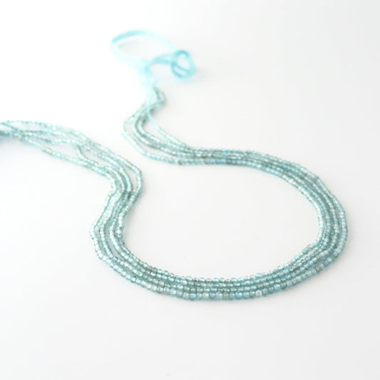 Faceted rondelle Aquamarine beads arranged neatly, highlighting their polished finish and handmade jewellery component quality