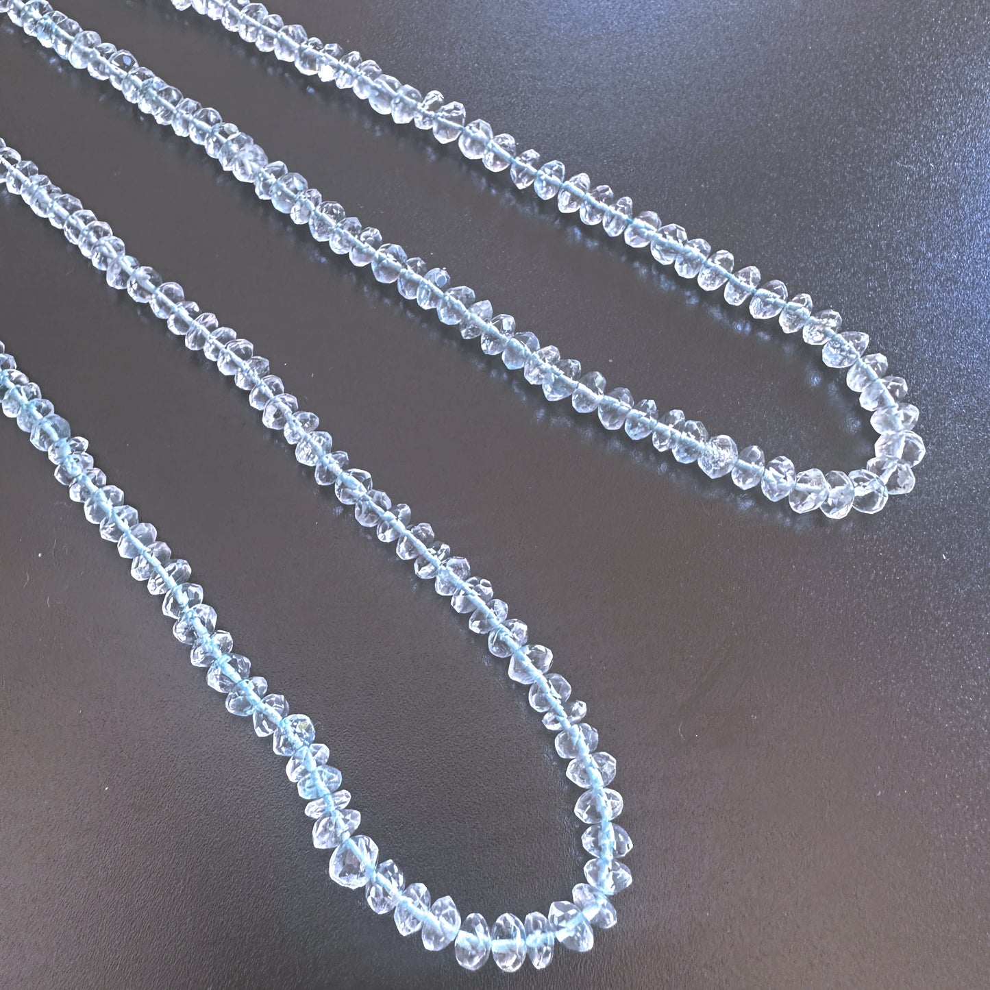 Aquamarine faceted rondelle beads in 4.5mm and 4.7-5mm sizes, 33cm strand with icy blue tones and polished sparkle.