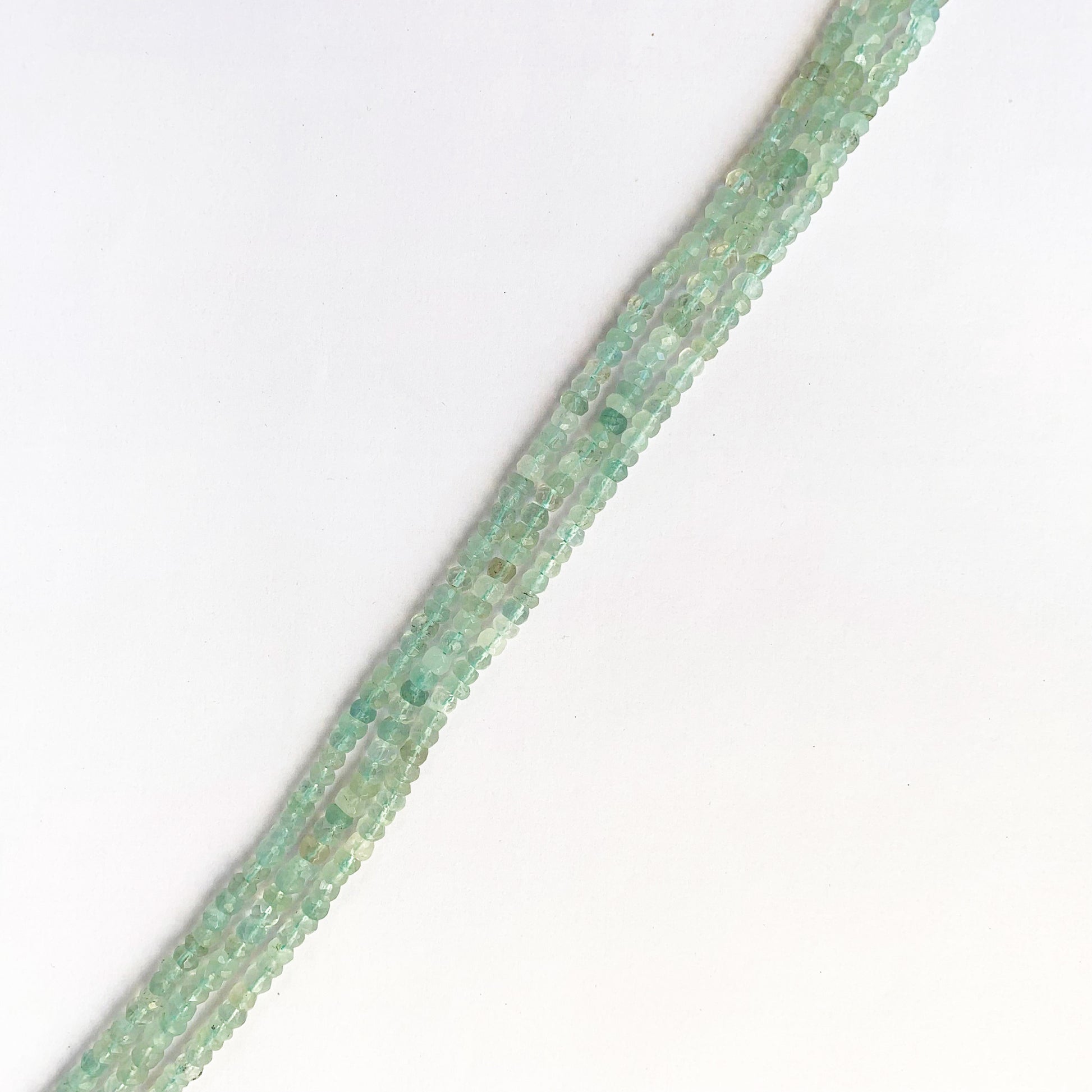 Strand of 31cm Aquamarine rondelle beads arranged in gradient blue hues with polished shine.