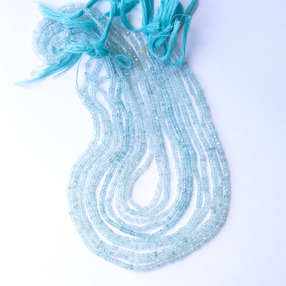 Genuine Aquamarine gemstone beads in faceted rondelle shape, displaying polish, shimmer, and natural beauty for jewellery crafting.
