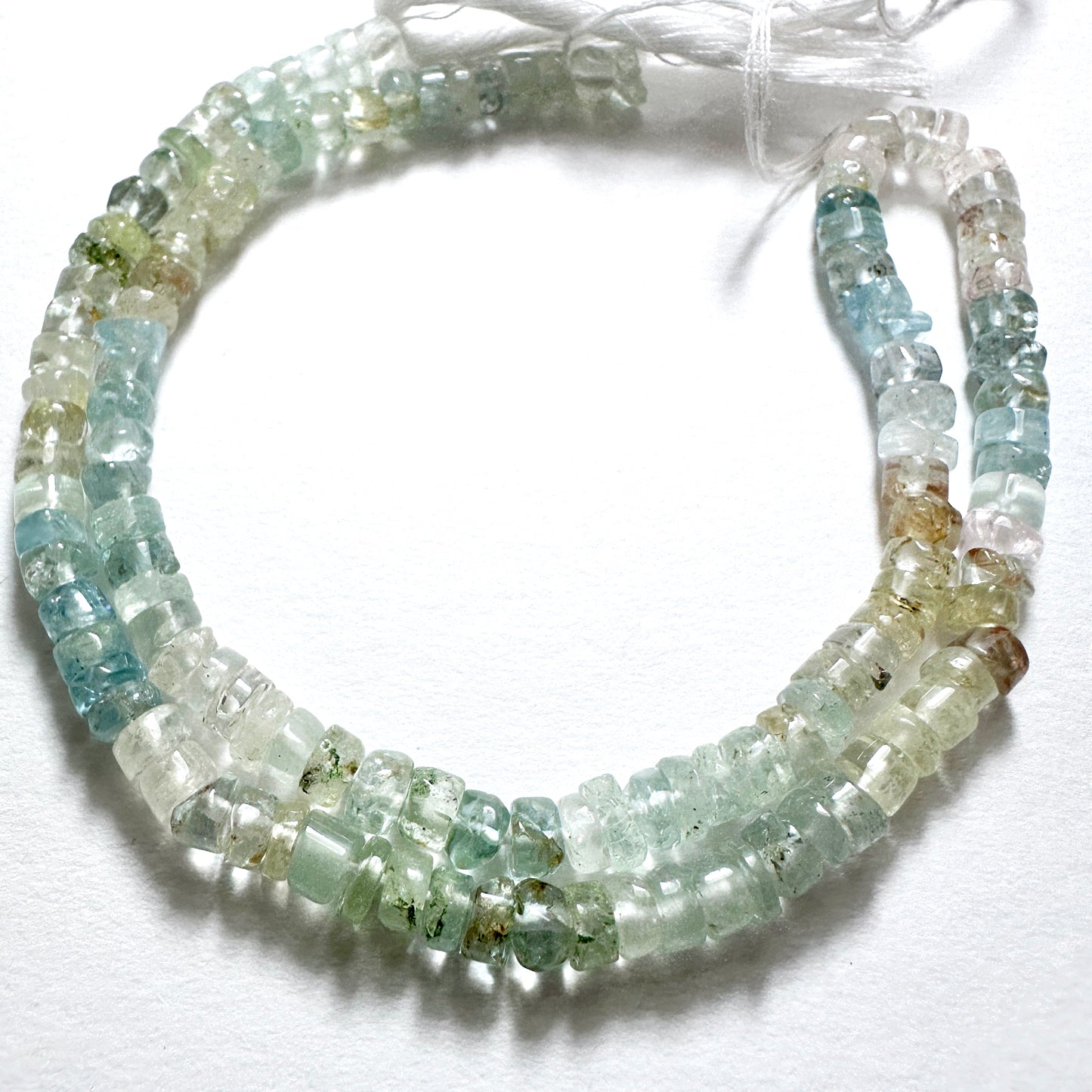 Aquamarine beads in smooth wheel cut, 4.5-4.8mm, arranged on a 33cm strand, ideal for handmade jewellery components.