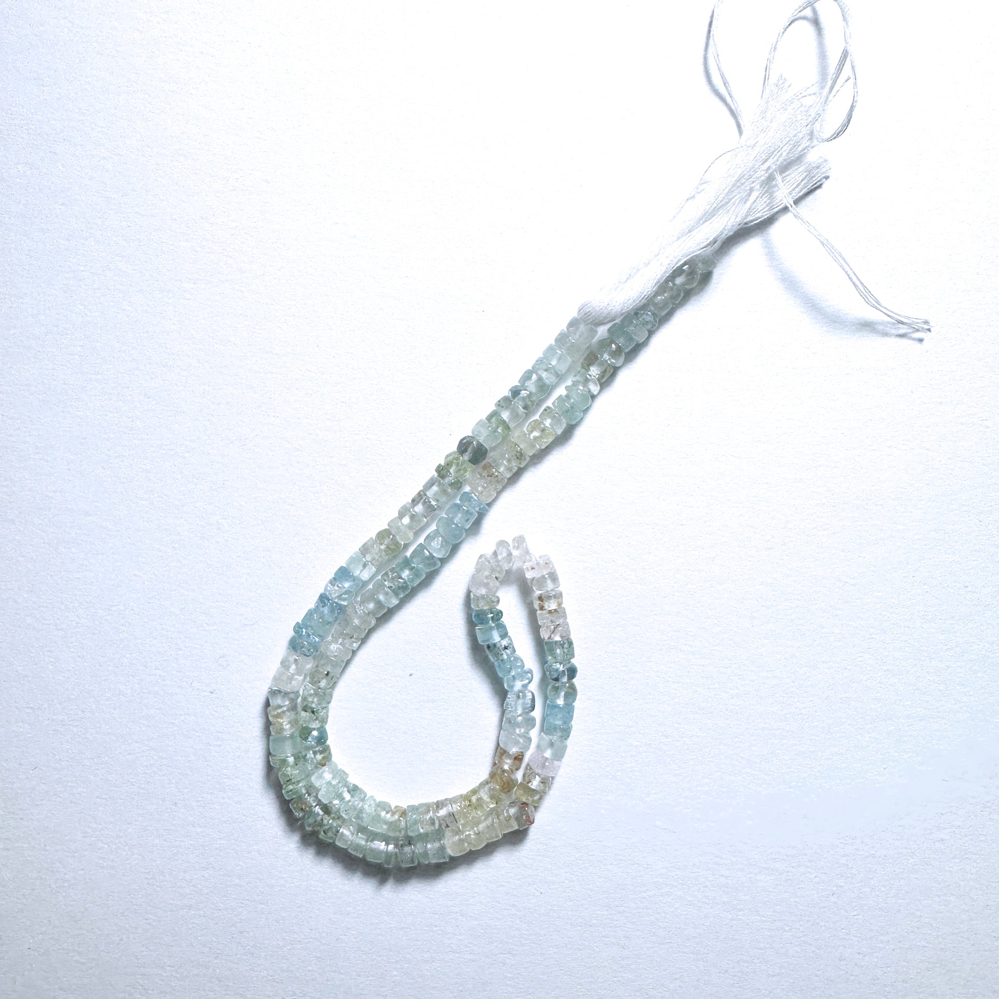 Aquamarine smooth wheel beads, 4.5-4.8mm, strung on 33cm strand, ideal for versatile handmade jewellery components.