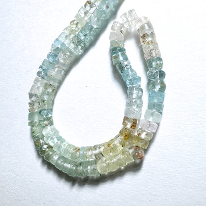 Close-up of aquamarine stone beads with smooth wheel cut, 4.5-4.8mm, showcasing clarity and polished finish.