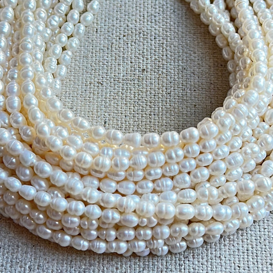 High-quality Baroque Pearls with glossy polish and creamy tones arranged for jewellery making.