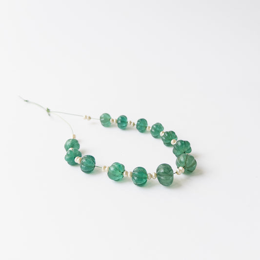 Beryl and Shell Pearl pumpkin cut beads showing carved ridges and glossy pastel tones for jewellery making.