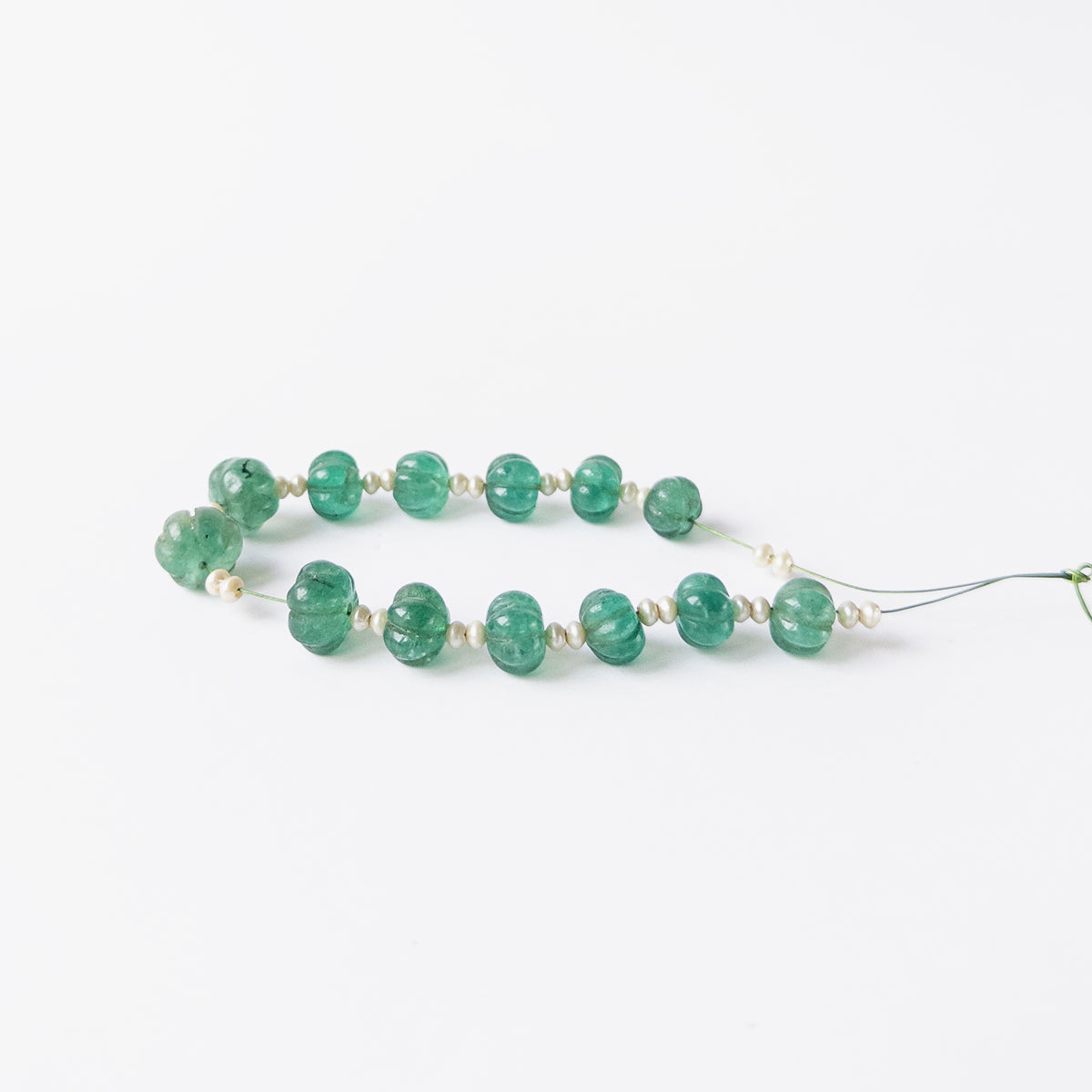 Authentic Beryl and Shell Pearl gemstone beads displaying carved detailing and elegant shine.