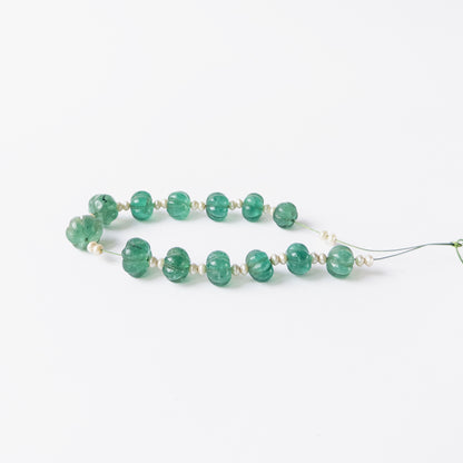 Authentic Beryl and Shell Pearl gemstone beads displaying carved detailing and elegant shine.