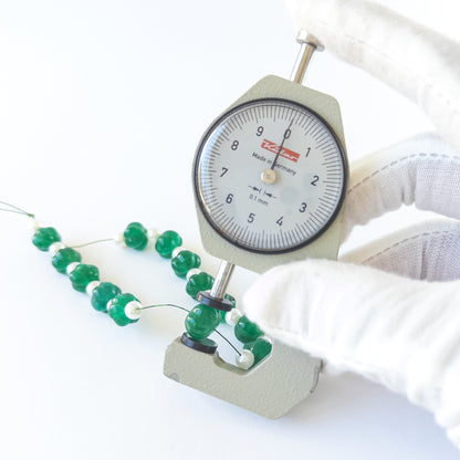 A dial gauge measures the Beryl and Shell Pearls pumpkin‑cut 9–10mm gemstone.