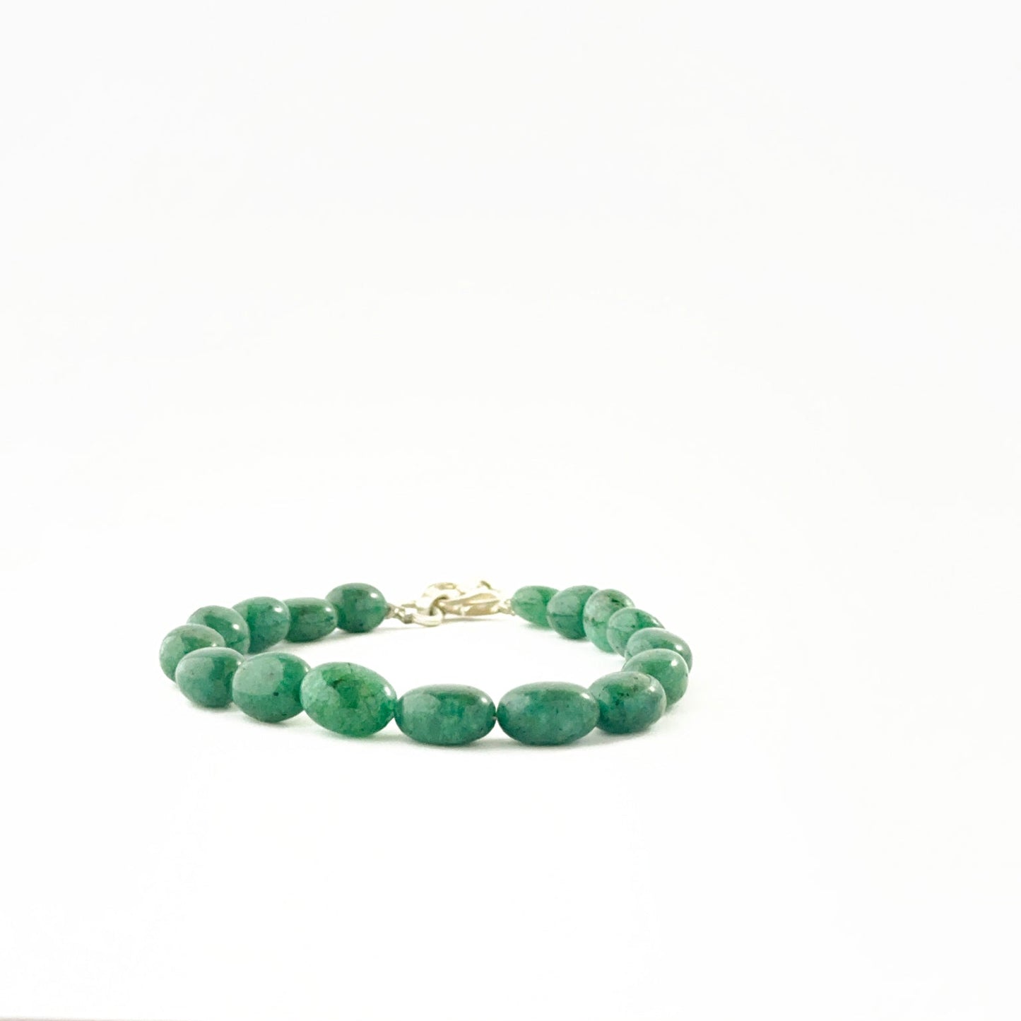 Smooth oval emerald bead bracelet showcasing 7–8mm beads with adjustable fit.