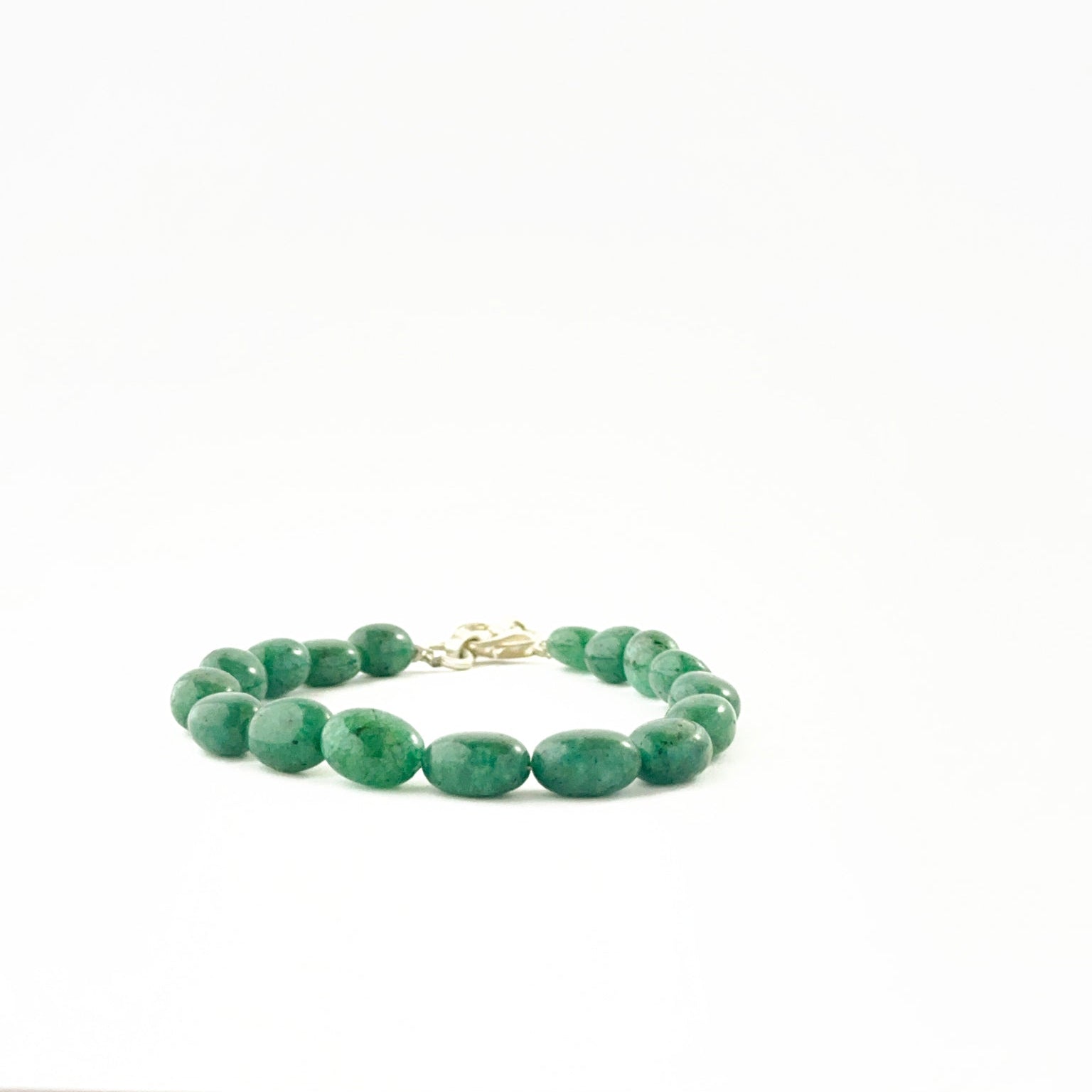 Smooth oval emerald bead bracelet showcasing 7–8mm beads with adjustable fit.