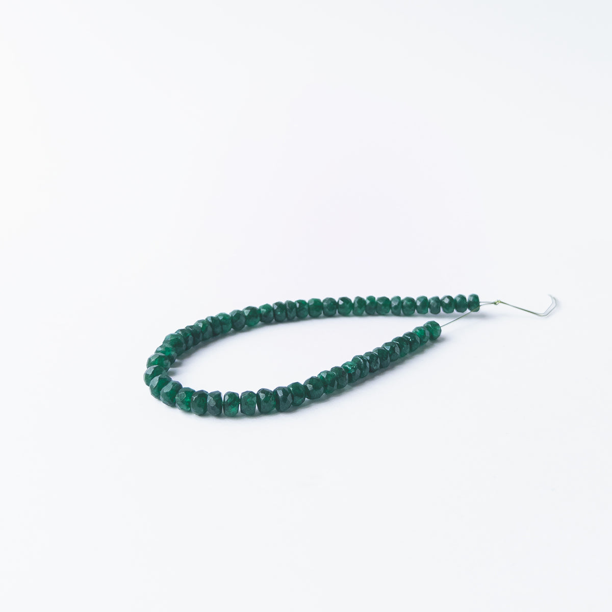 Authentic Beryl gemstone beads displaying soft colour variation and polished faceted shine.