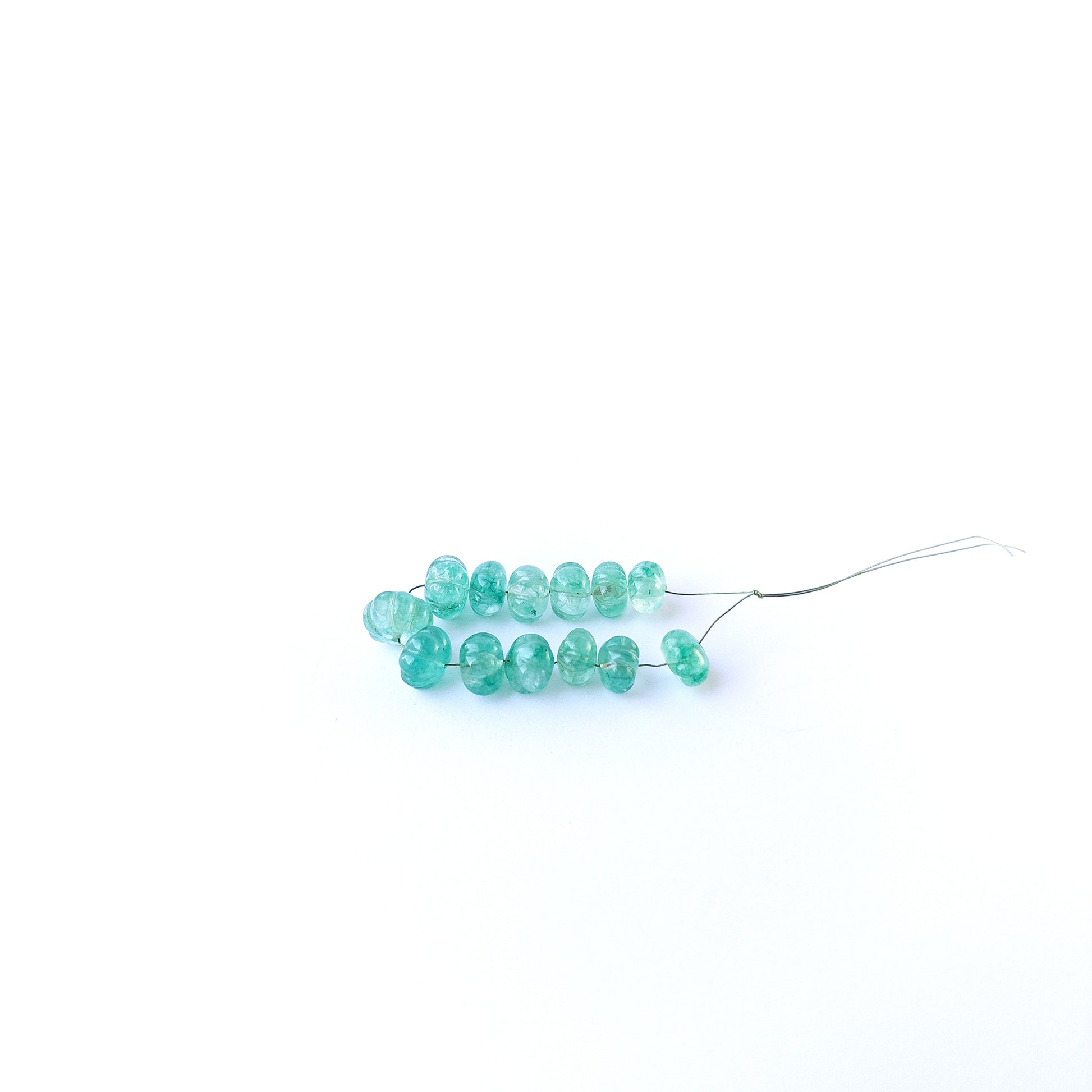 Handmade jewellery components with natural beryl pumpkin‑cut beads arranged in a 13‑piece set.