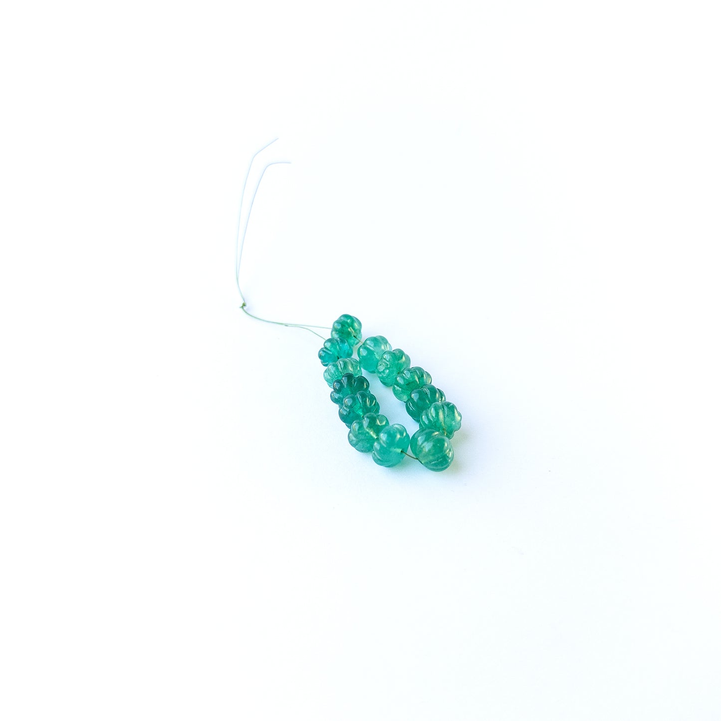 Handmade jewellery components with natural beryl pumpkin‑cut beads arranged in a 13‑piece set.