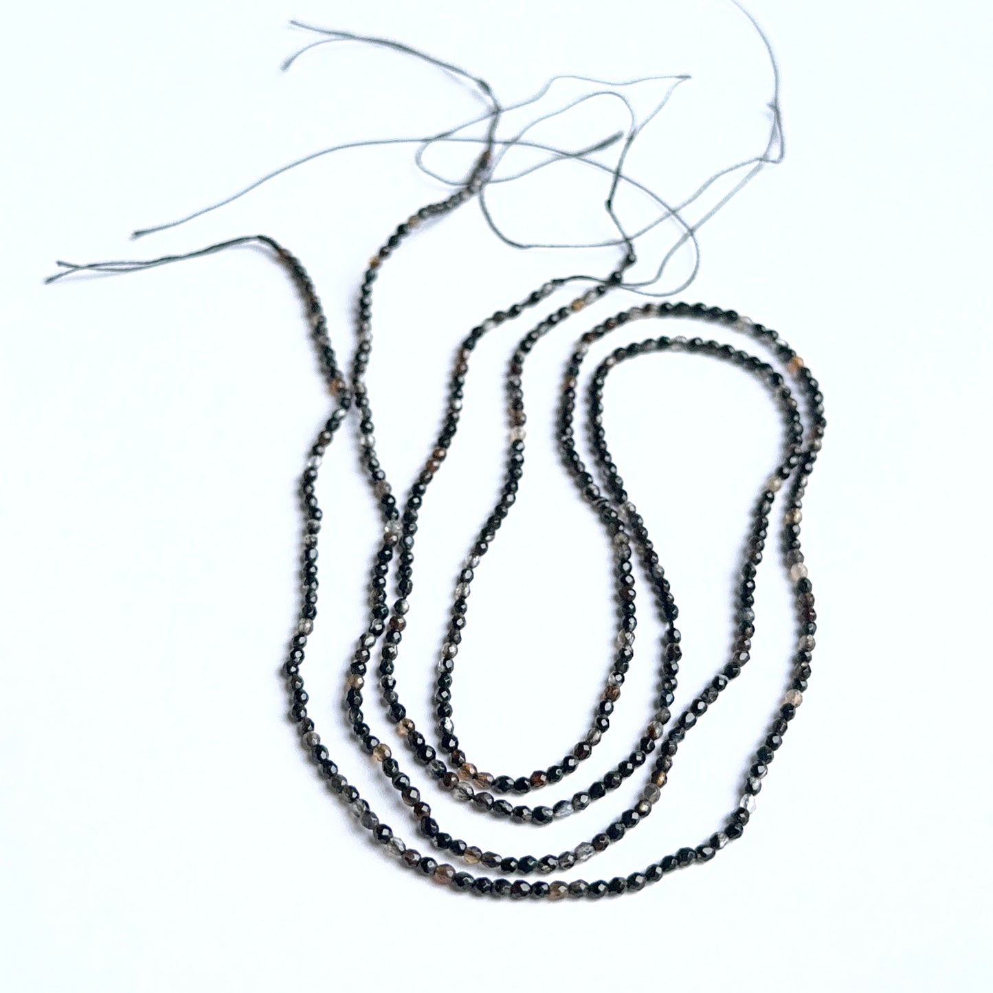 Close‑up of black fluorite stone beads highlighting their sparkle and natural gemstone quality for DIY jewellery.