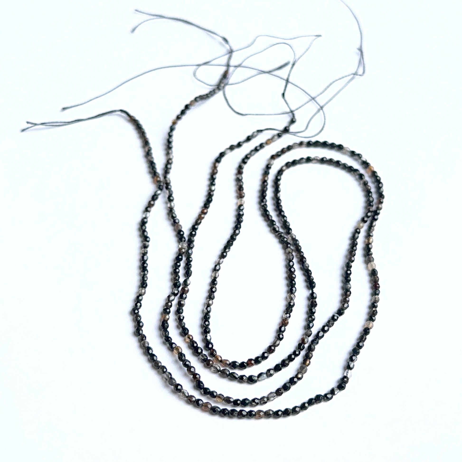 Close‑up of black fluorite stone beads highlighting their sparkle and natural gemstone quality for DIY jewellery.