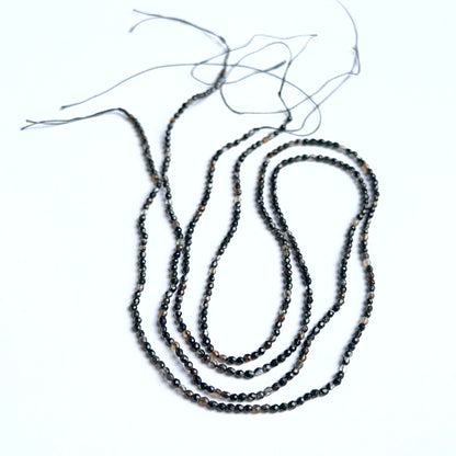 Close‑up of black fluorite stone beads highlighting their sparkle and natural gemstone quality for DIY jewellery.