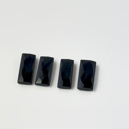  Individaal pieces of Black Onyx beads palced on a white background